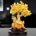 Citrine-coloured resin turtle money tree Feng Shui ornament on display.