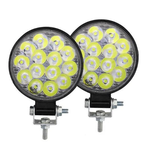 White LED mini round auxiliary work light with aluminium housing for vehicle mounting.