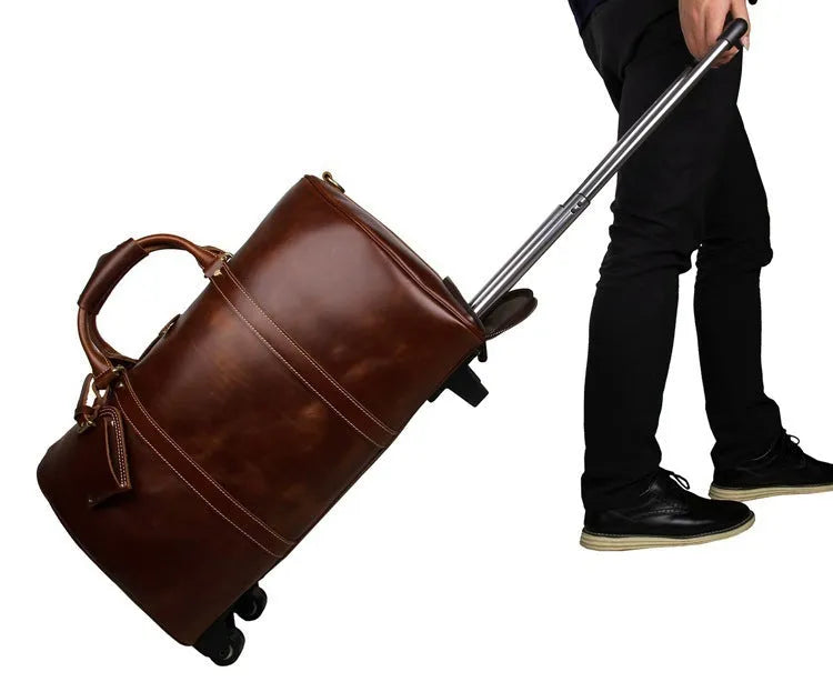 21 inch cowhide leather trolley bag in brown glossy finish, front view showing handle and wheels