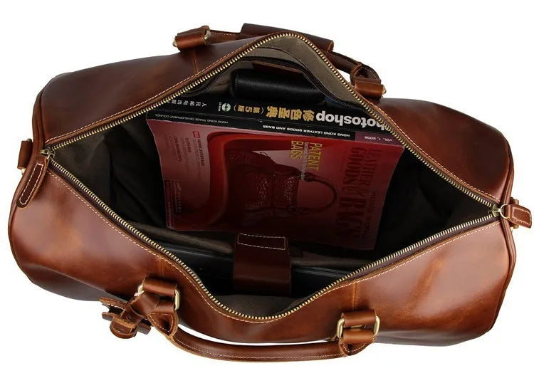 21 inch cowhide leather trolley bag in brown glossy finish, front view showing handle and wheels
