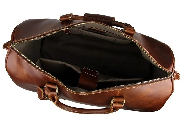 21 inch cowhide leather trolley bag in brown glossy finish, front view showing handle and wheels