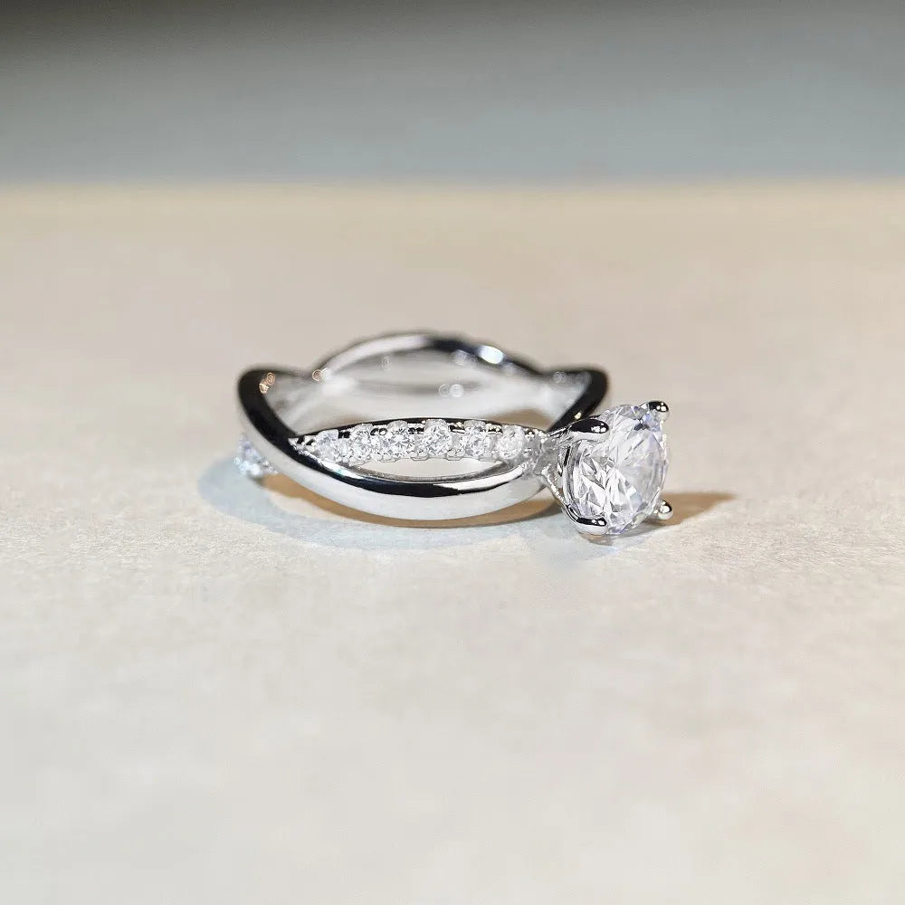 Geometric twisted arm silver ring with 1 karat moissanite centre stone in four-claw setting
