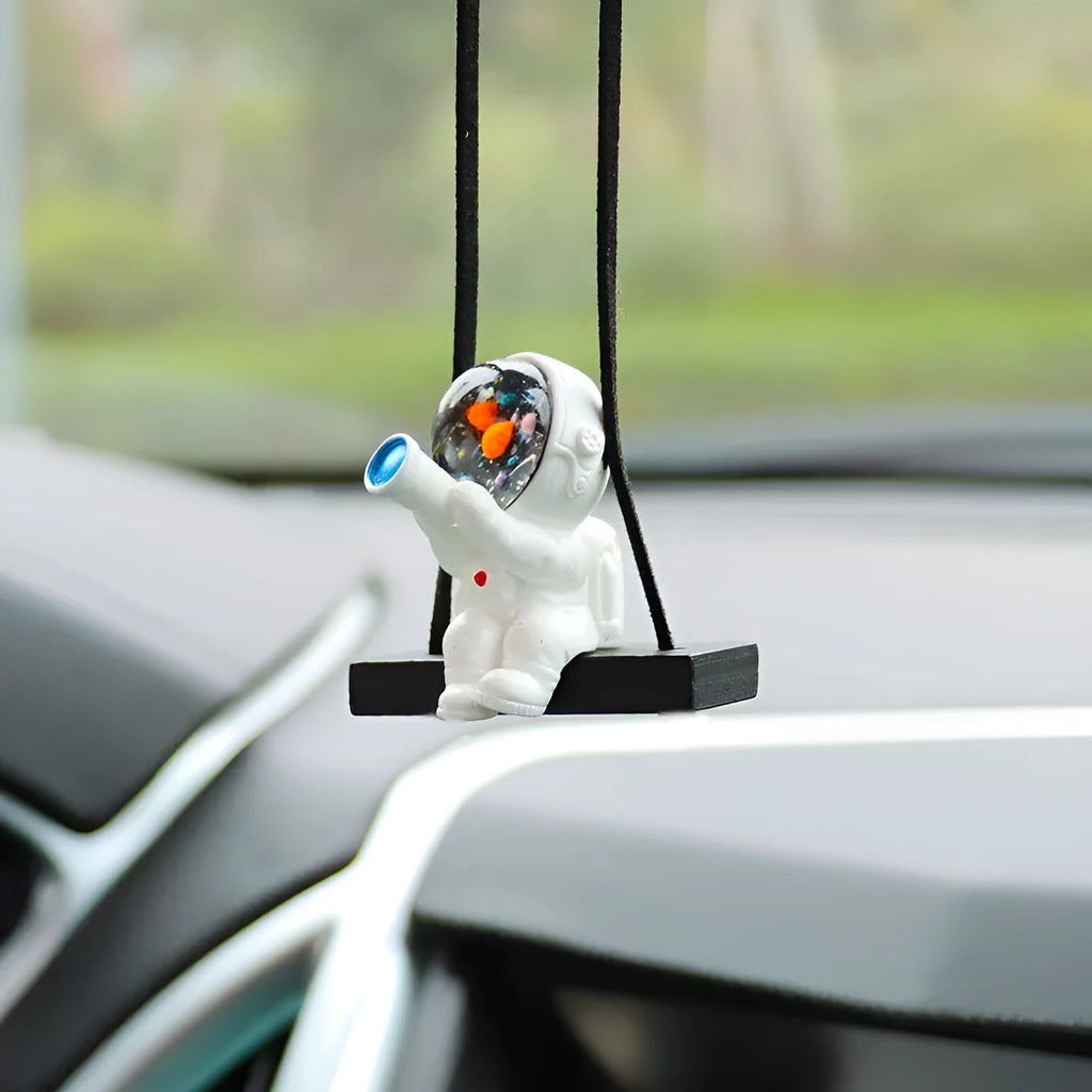 Resin astronaut car pendant in one of five cartoon colour designs
