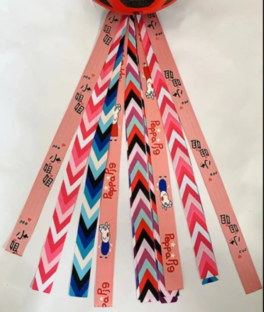 Colourful decorative ribbon streamers attached to a children safety helmet for skating or skiing
