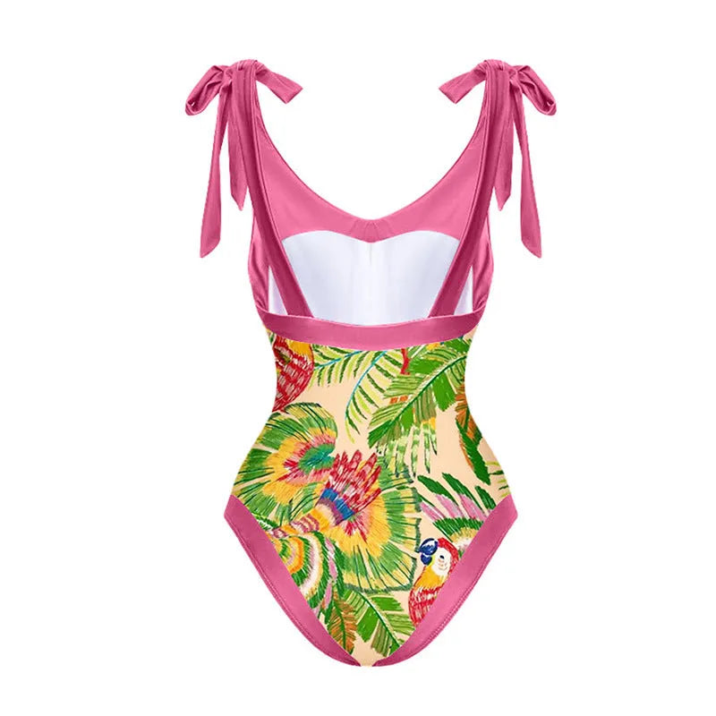 Pink floral print women's one-piece swimsuit with V-neck and matching skirt on beach