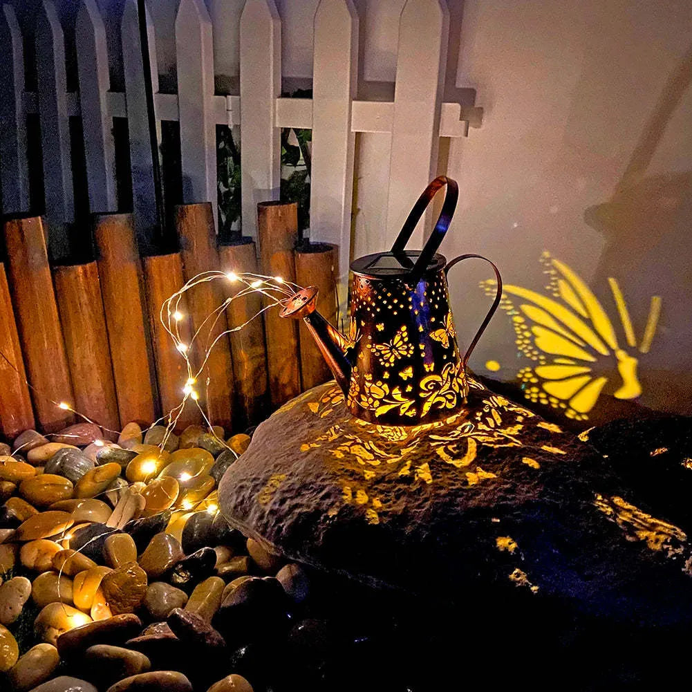 Tapered butterfly pattern iron solar garden lamp with warm white LED light.