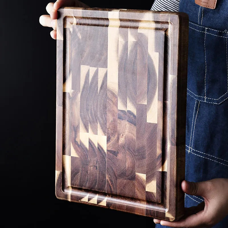 Brown solid acacia wood chopping board with 3cm thickness on a kitchen counter.