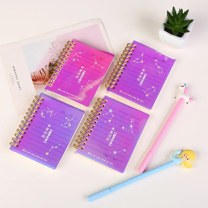 Set of four A7 spiral-bound pocket notebooks with different coloured PP covers showing Constellation, Sakura, Ocean, and Universe designs.