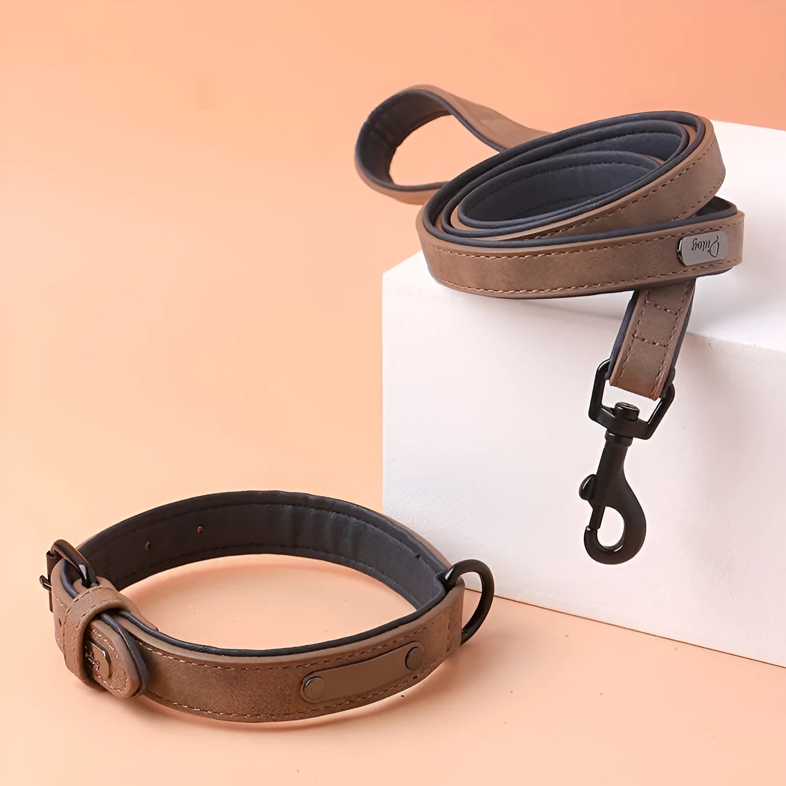Adjustable dog collar in purple showing front PU material and back microfiber fabric, with a secure buckle closure.