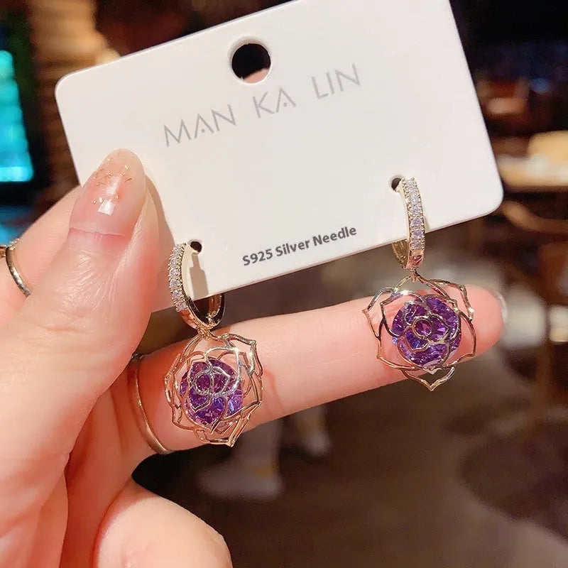 Women's geometric copper earrings with zircon and rose design elements in various colours