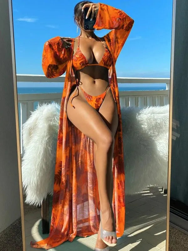 Women's long sleeve bikini set with floral pattern and matching robe on a hanger.