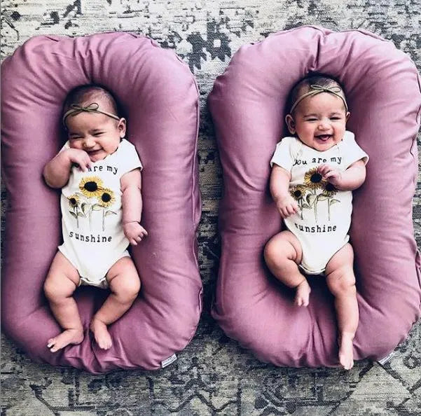Beige portable cotton baby nest crib cushion measuring 75cm by 45cm for infant sleep.