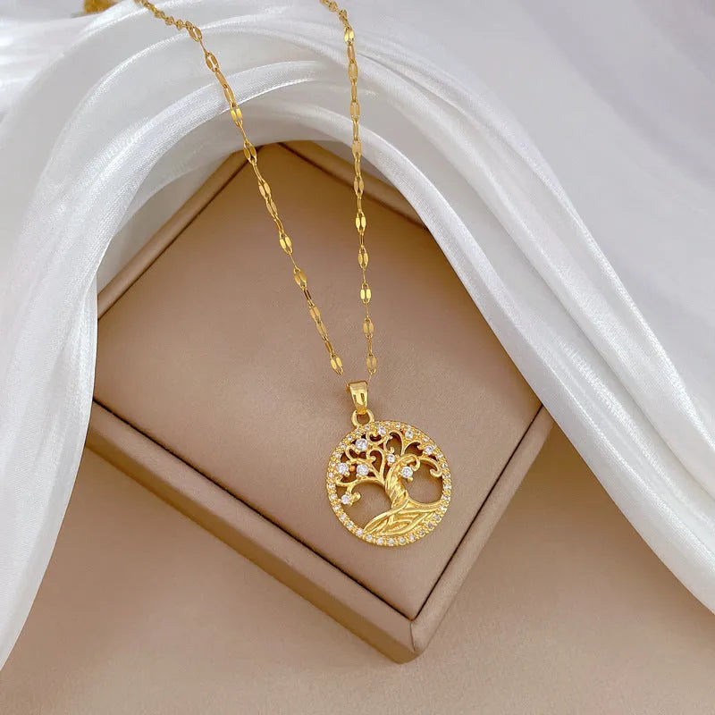 Gold-plated necklace with mother of pearl lucky tree pendant and rhinestone zircons on an adjustable chain.