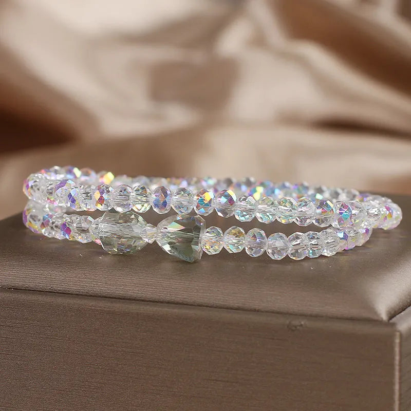 Women's double-circle crystal bow bracelet in white, green, and pink colour options on display
