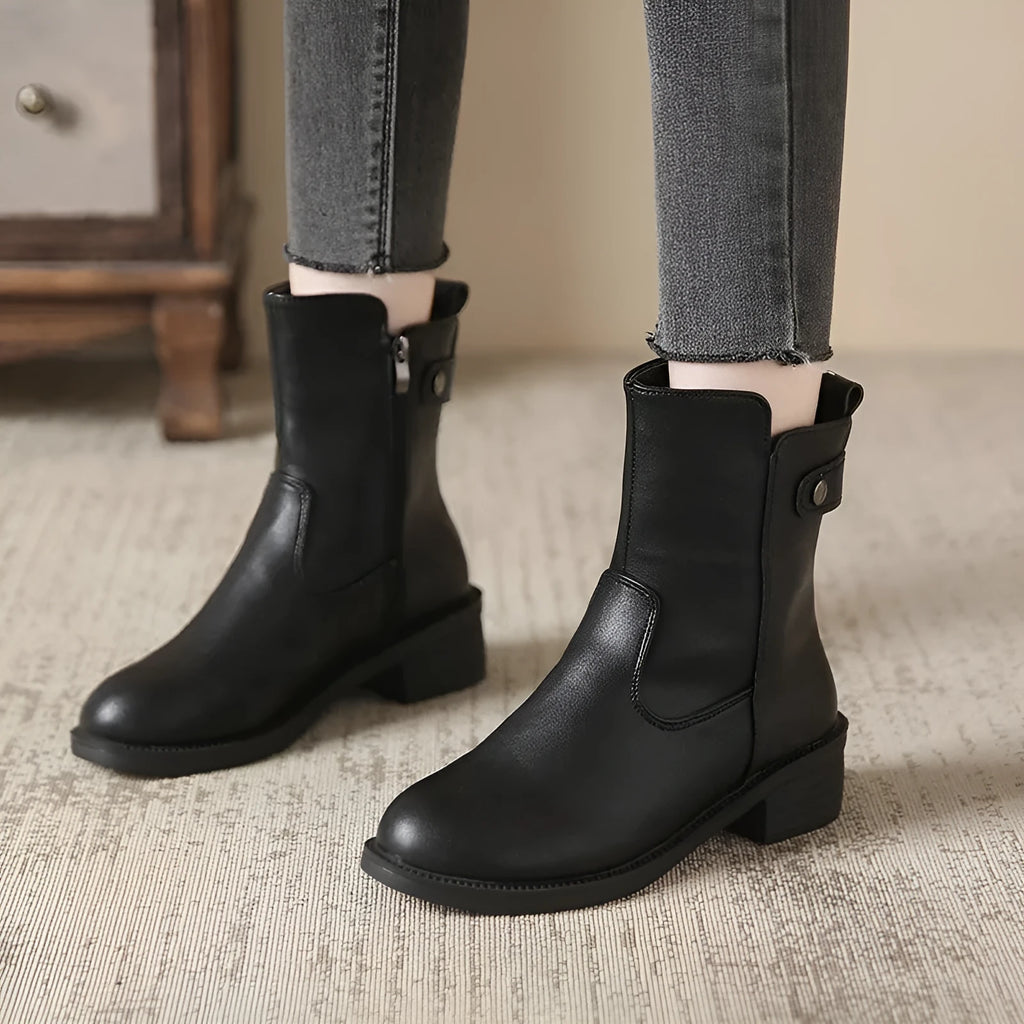 Black women's ankle boots with a round toe, side zip, and a low rubber sole.