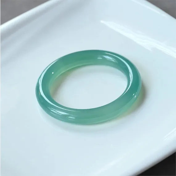 Natural agate wide tyre bracelet showing colour variations including pink, white, blue and green options