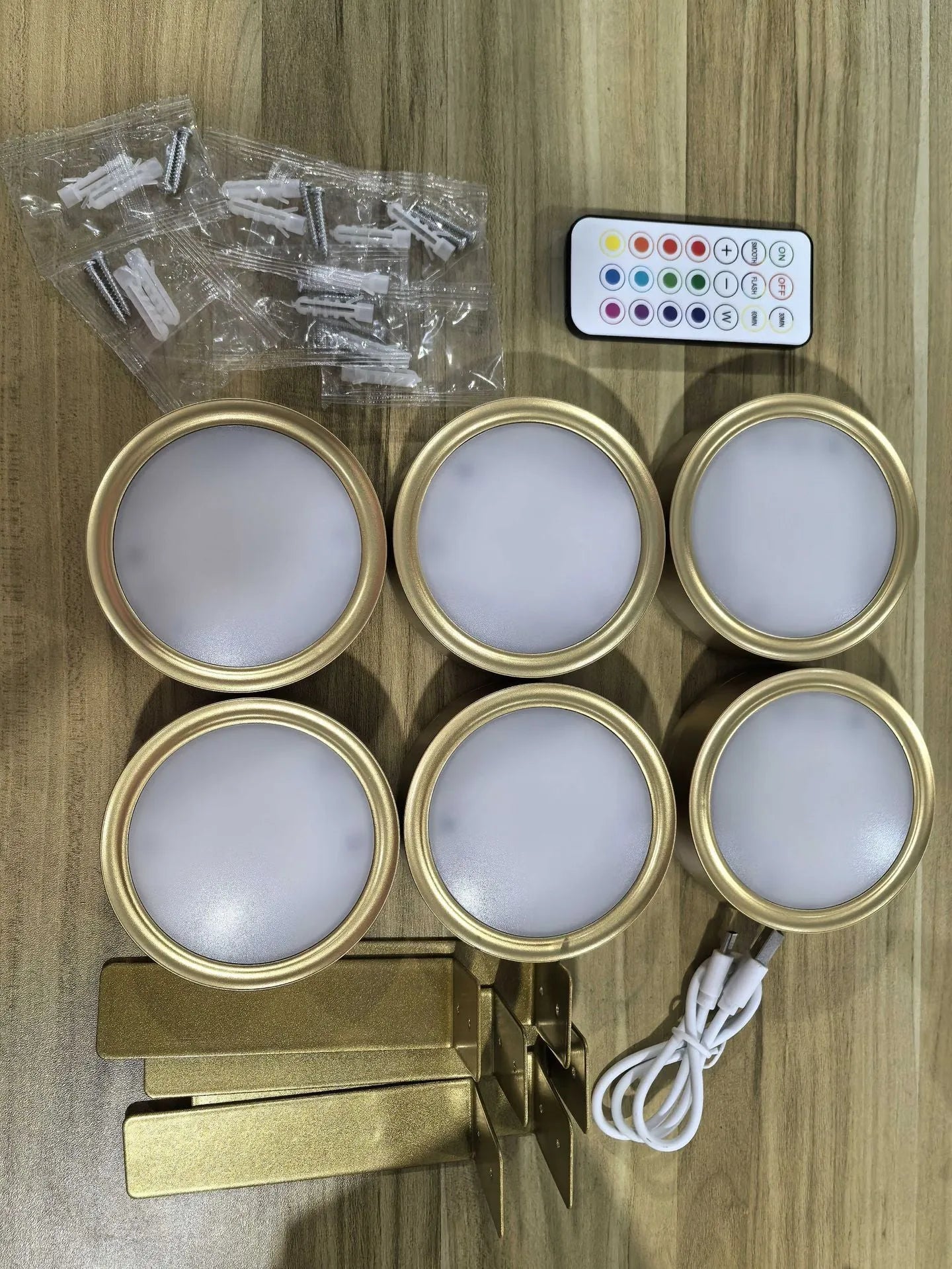 Wireless rechargeable LED painting lamp with magnetic belt attached to a metal frame, remote control nearby.
