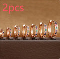 Set of gold, rose gold, and silver perforated circle stud earrings in multiple sizes on a flat surface.