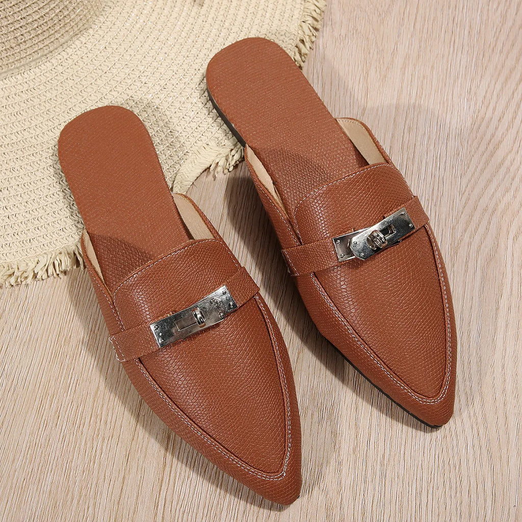 Light brown women's pointed toe low heel slippers with a rubber sole on a plain background.