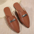 Light brown women's pointed toe low heel slippers with a rubber sole on a plain background.