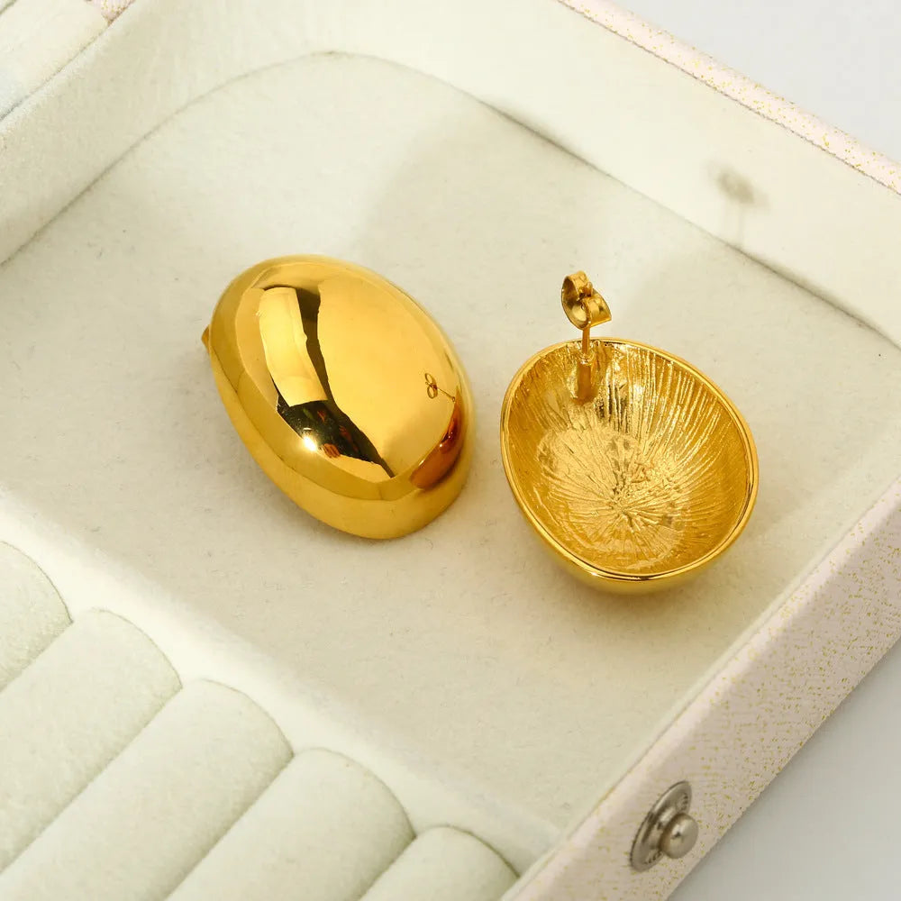 Geometric women's earrings with a gold glazed finish and simple line designs on a white background.