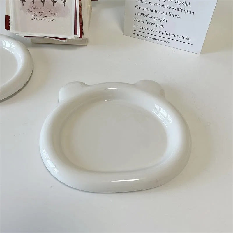 White ceramic plate with doodle design showing bear pattern, suitable for microwave use