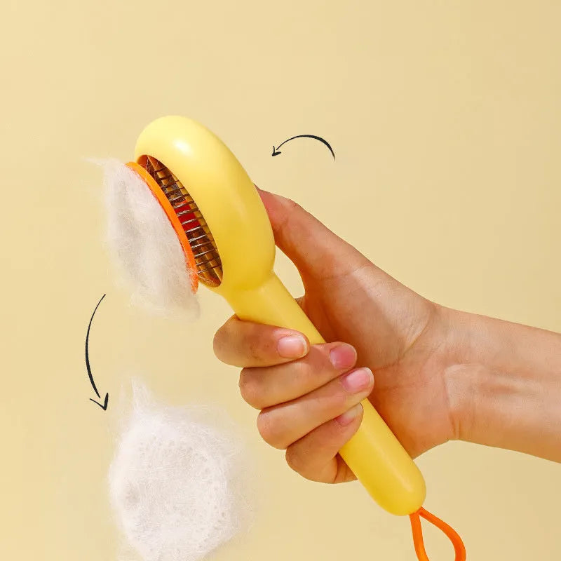 Small yellow plastic duck-shaped pet grooming comb with needle bristles.