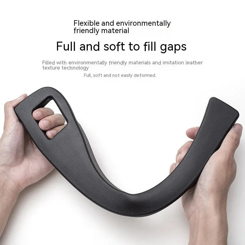 Black plastic car seat gap storage box with handle installed between car seats