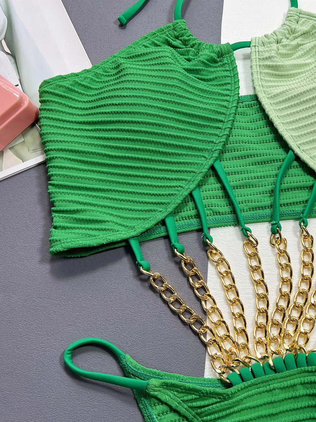 Green solid-colour one-piece swimsuit for women on a mannequin, showing the front design.