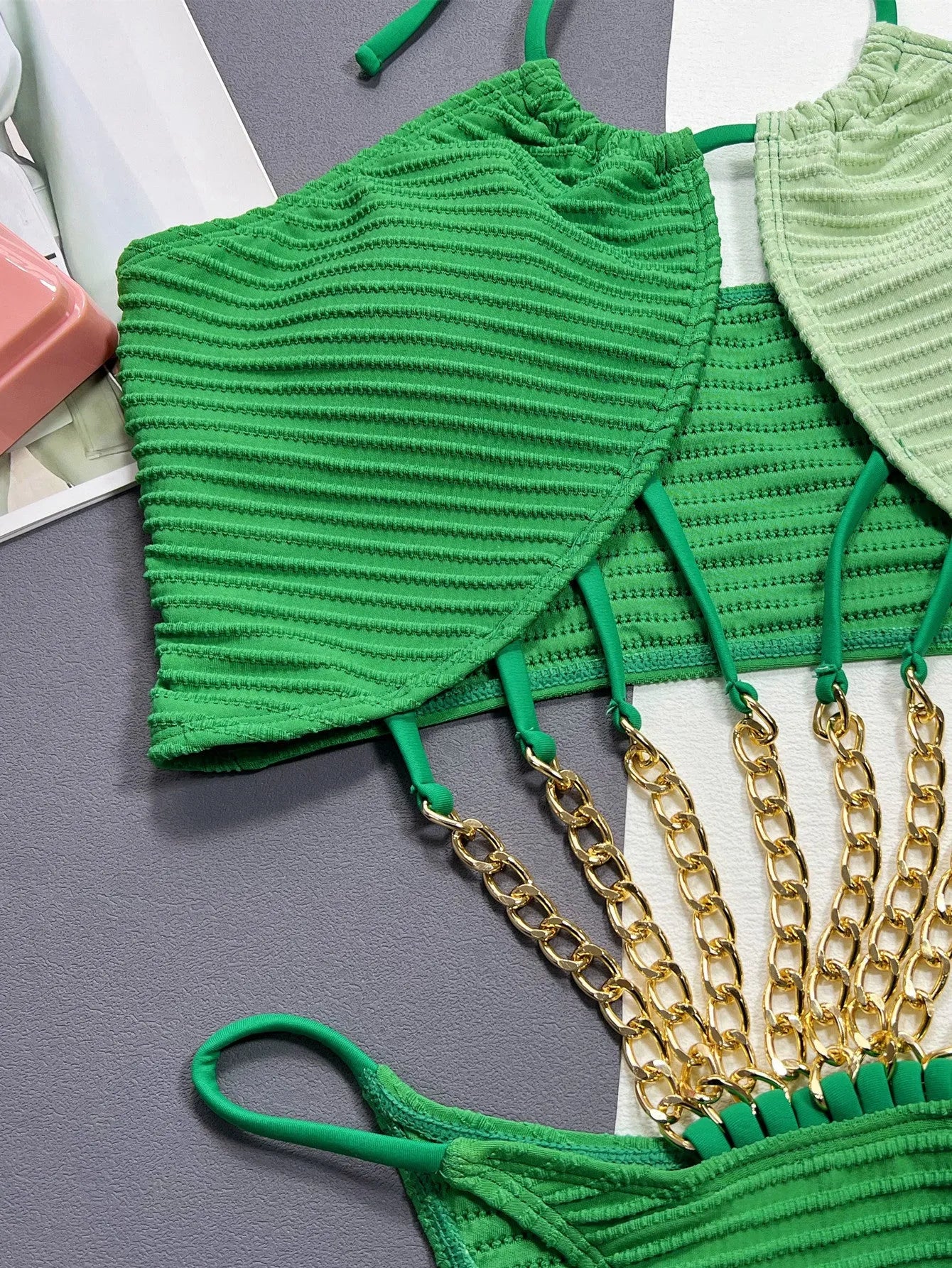 Green solid-colour one-piece swimsuit for women on a mannequin, showing the front design.