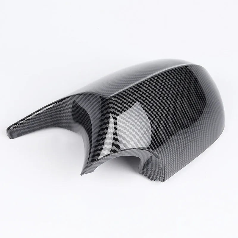 Pair of black ABS plastic rearview mirror housings for BMW 3 Series E90 on a white background.