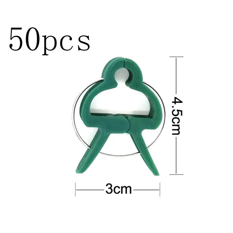 Green plastic plant fixing clips for supporting climbing vegetables like tomatoes and cucumbers