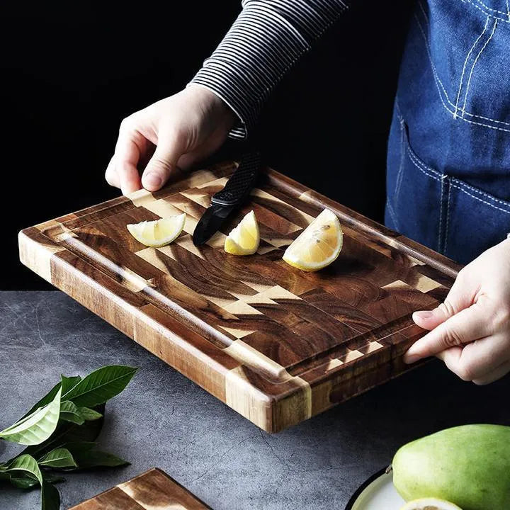 Brown solid acacia wood chopping board with 3cm thickness on a kitchen counter.