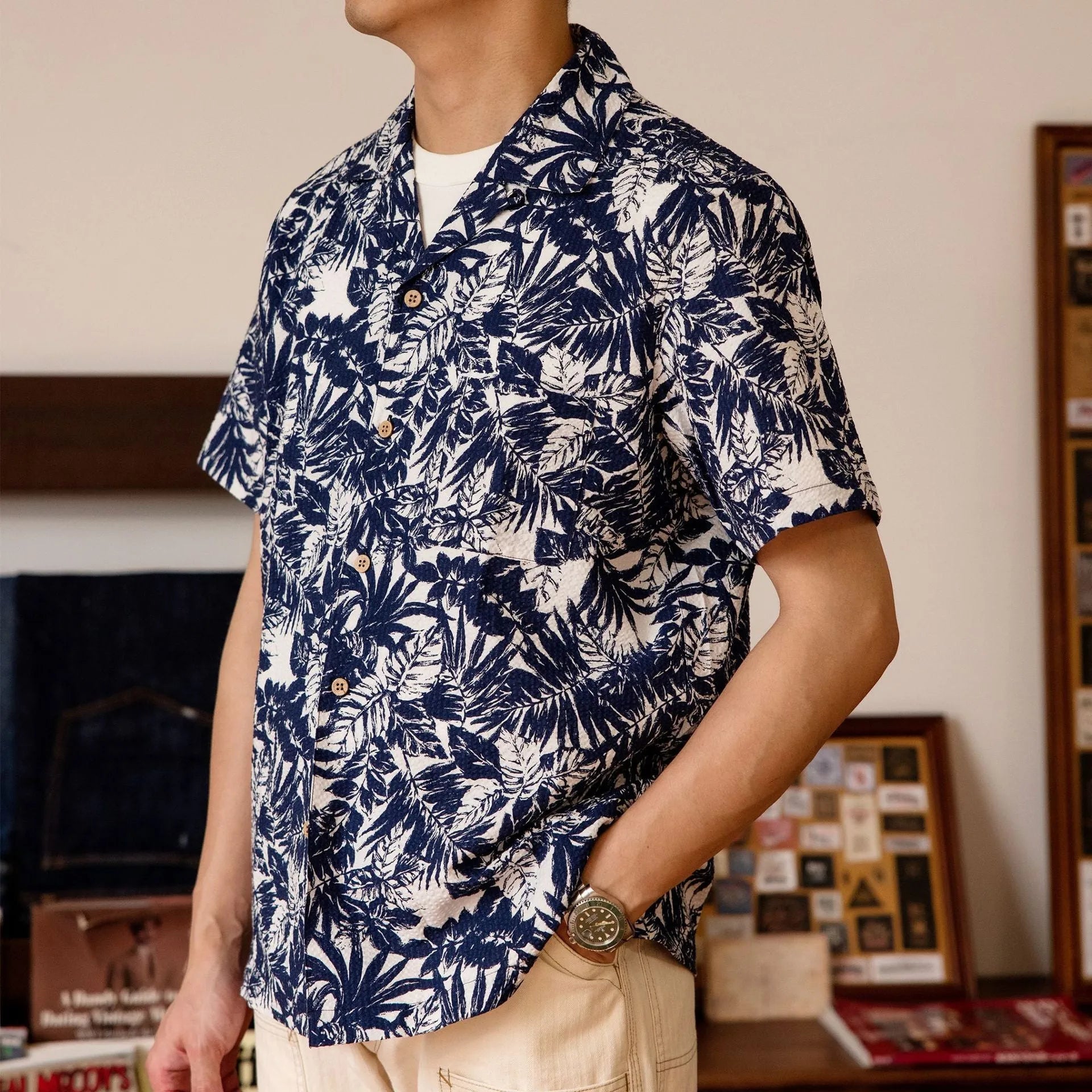Man wearing a vintage green seersucker shirt with floral print and a Cuban collar.