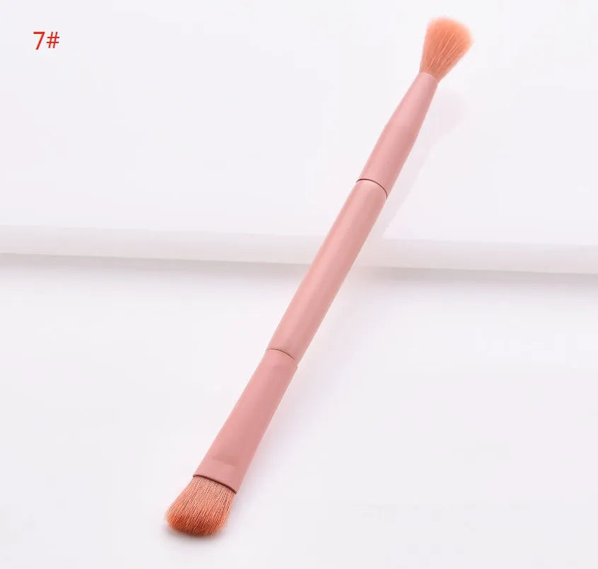 Ten makeup brushes with wooden handles arranged showing different brush head types including powder, foundation and double-headed tools