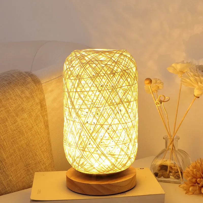 Brown hemp rope Sepak Takraw ball desk lamp with solid wood base on a desk.