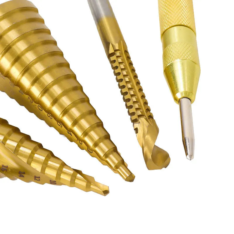 High-speed steel cone step drill bits and a centre punch set on a workshop bench