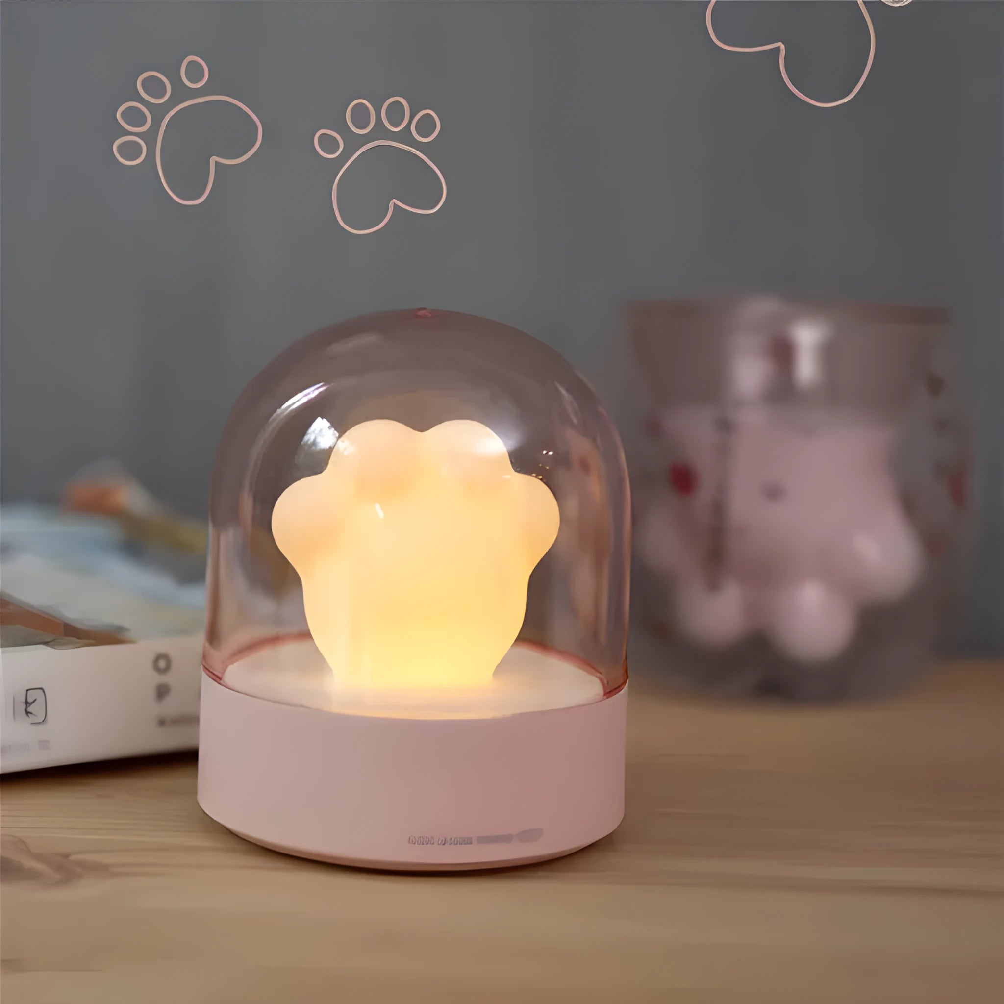 Grey cat paw USB night light with rotating illumination and music box function on wooden desk