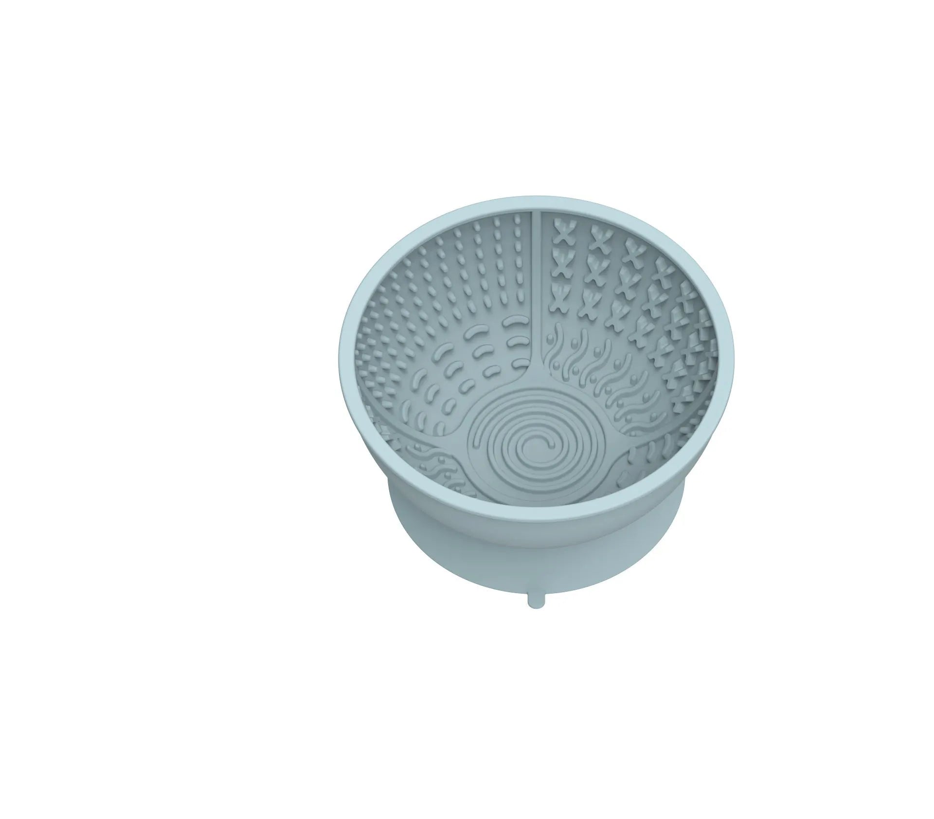 Cyan silicone dog bowl with slow feeder ridges and suction cup base on a table.