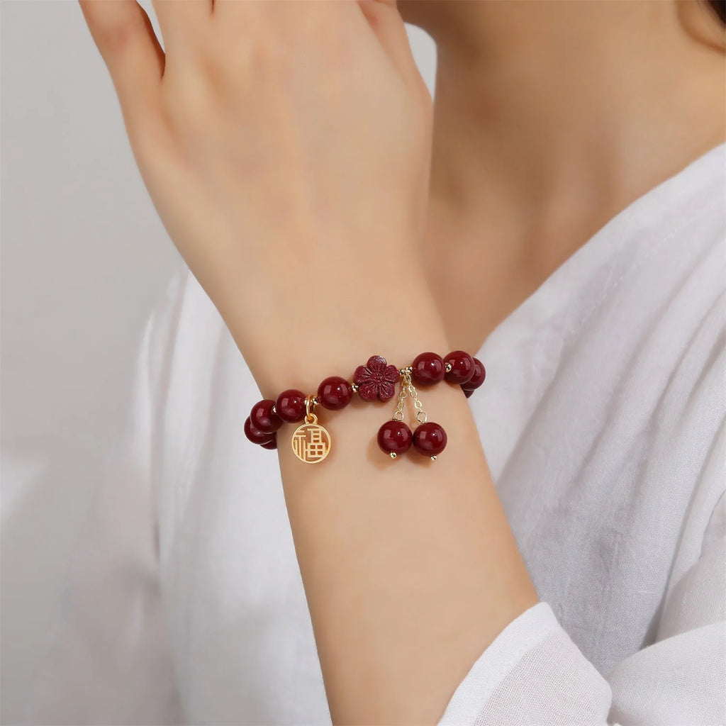 Women's national style cinnabar bracelet with fu character design and peach blossom tassel detailing