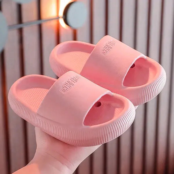 Mixed colour children's EVA slippers with non-slip soles in sizes for ages 24-35.