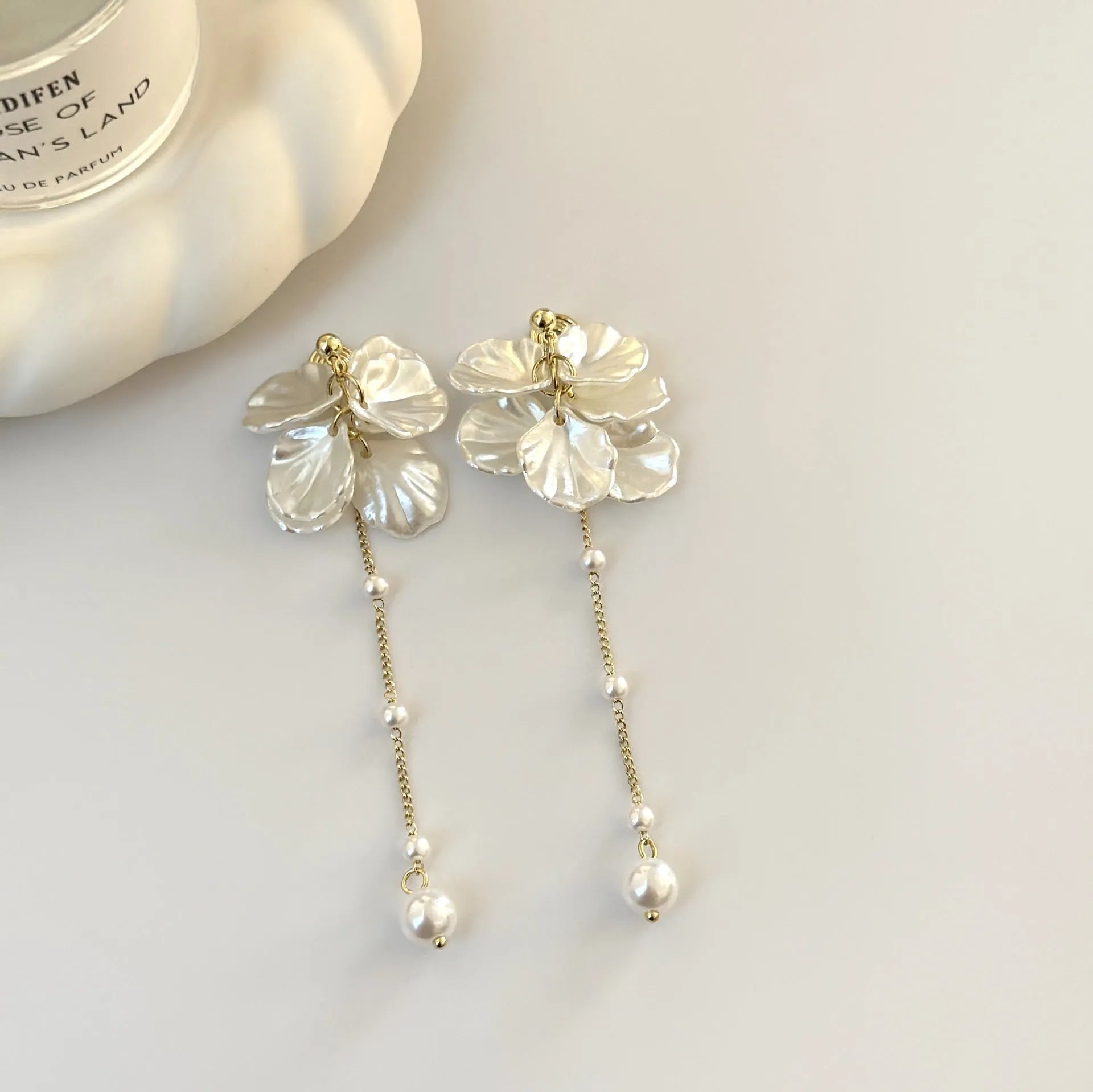 Women's acrylic earrings with pearl and shell tassel design measuring 8.8cm length