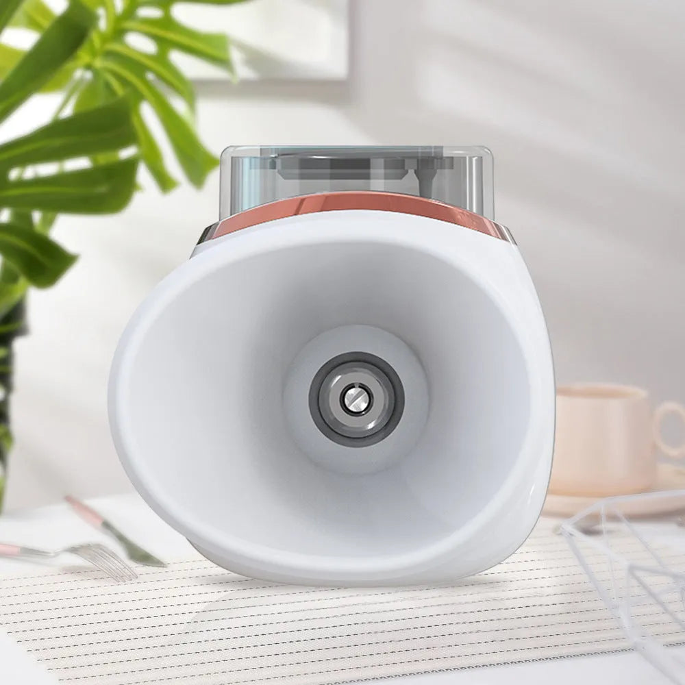 White and purple household eye humidifier with charging cable on a table.