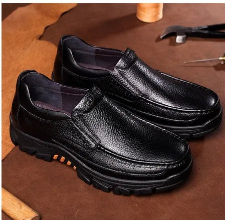 Men's black and brown cowhide leather business casual slip-on shoes with a rubber sole.
