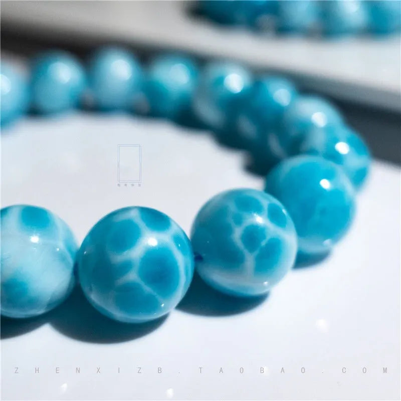 Blue and natural toned handmade bodhi bracelet with sea-pattern stones and pearl elements