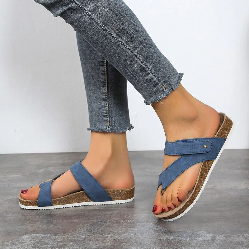 A pair of thick-soled flat toe ring flip-flops in a solid colour on a white background.
