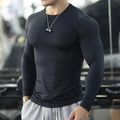 Men's slim fit black fitness tights with long sleeves for running and gym workouts.