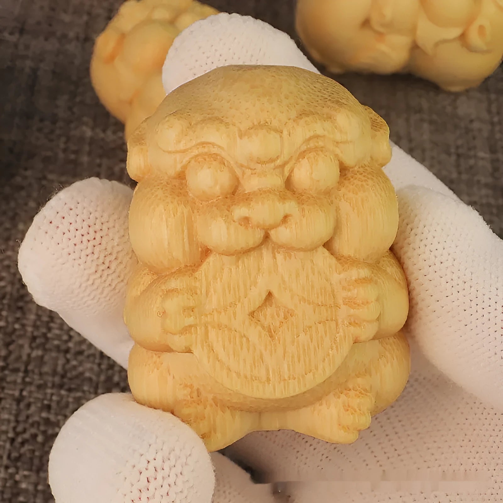 Solid bamboo Take Money carving ornament on a surface, showing natural grain and carved symbol.