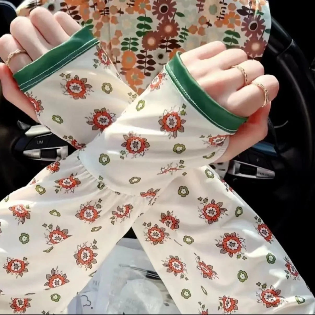 Printed viscose fibre sun protection oversleeves in floral design with elasticated cuffs.