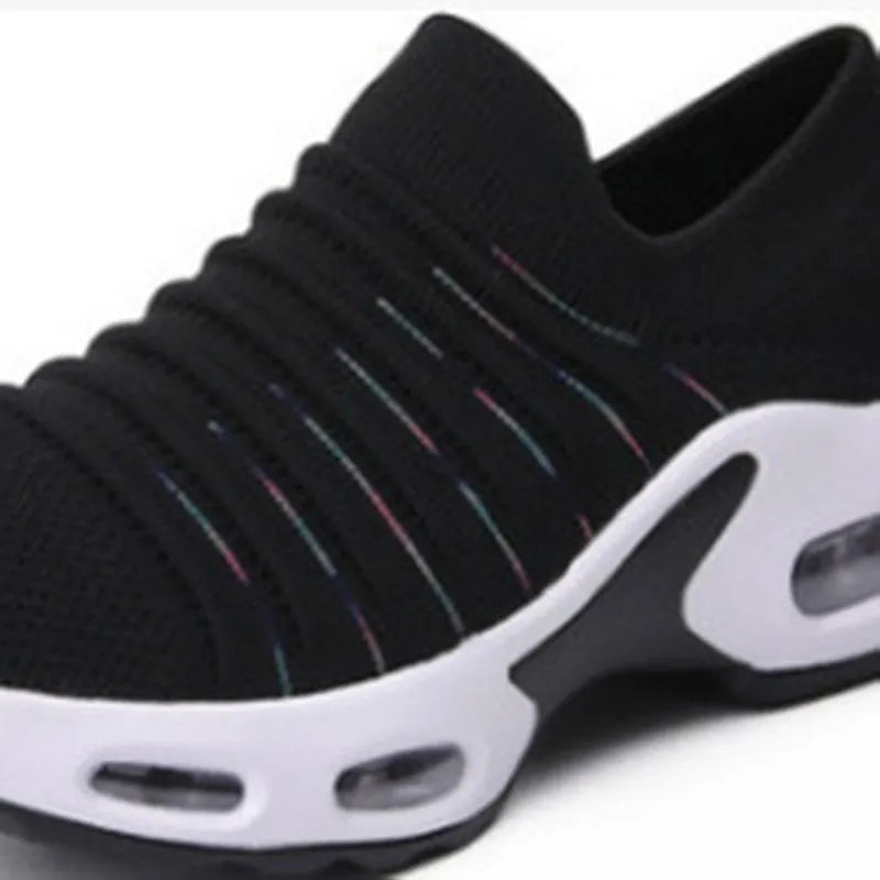 Women's stretch knitted sock shoes in various colours showing mesh upper and round toe design.